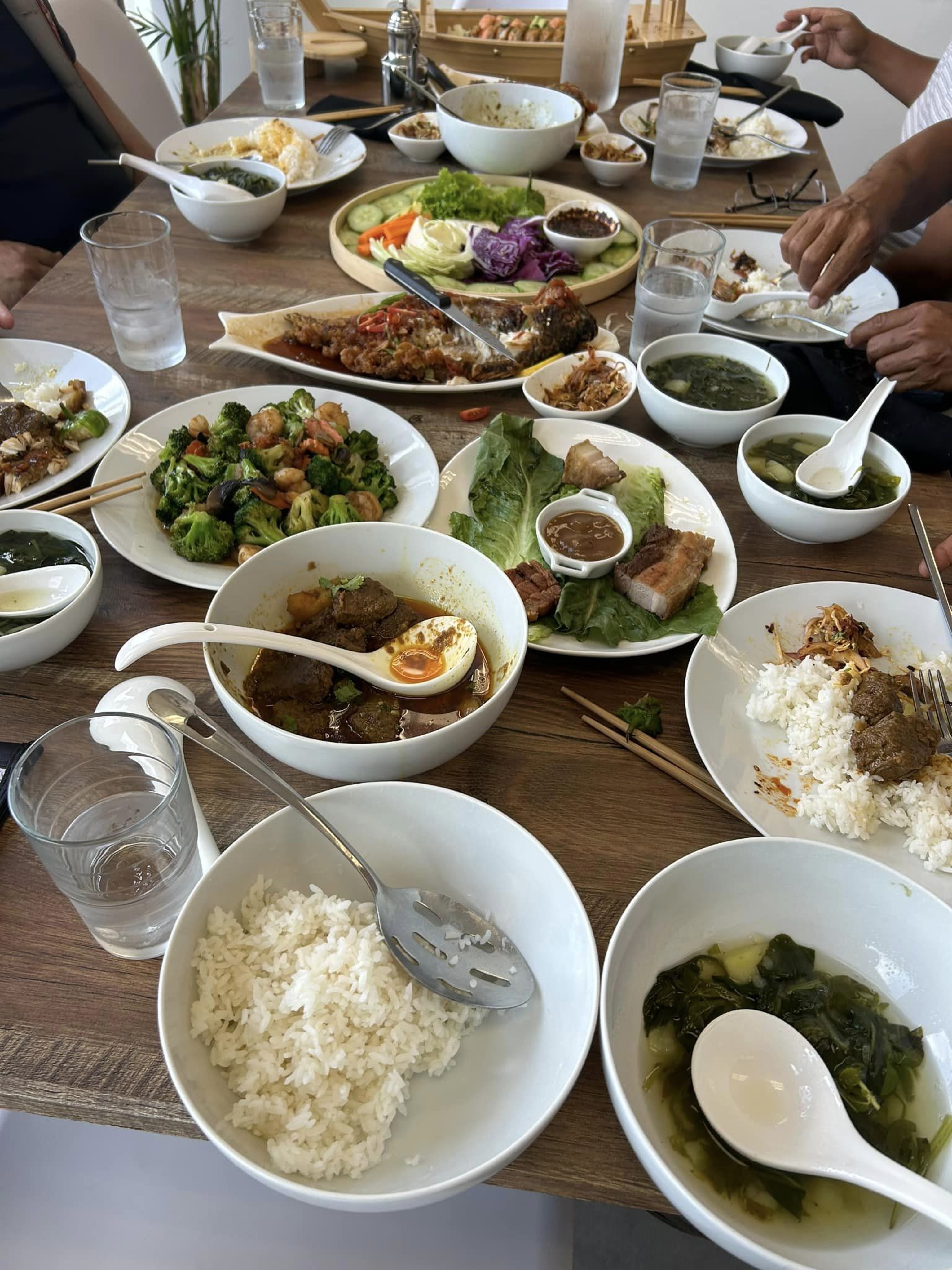 Family-style CHIN Fusion table spread with Burmese dishes